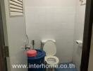 Compact bathroom with blue accents and essential amenities