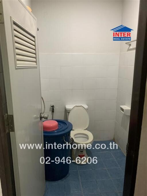 Compact bathroom with blue accents and essential amenities