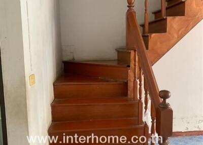 Wooden staircase with varnished handrails in a residence