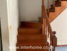 Wooden staircase with varnished handrails in a residence