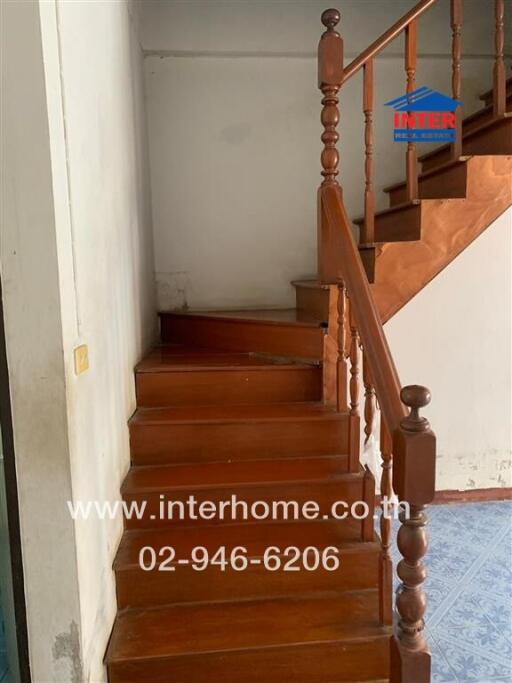 Wooden staircase with varnished handrails in a residence