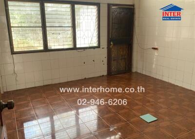 Spacious kitchen with large windows and tiled flooring