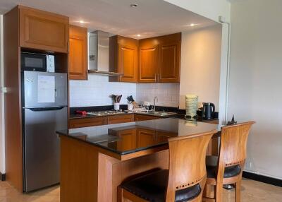 Modern kitchen with wooden cabinets and breakfast bar