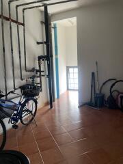 Utility room with bicycles and exposed piping