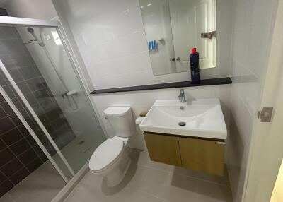 Modern bathroom with white ceramic fixtures and walk-in shower