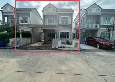 Exterior view of a modern duplex house with car parking