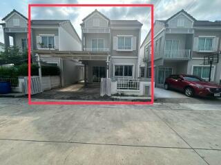 Exterior view of a modern duplex house with car parking