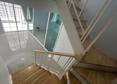 Modern staircase in a well-lit interior with reflective surfaces