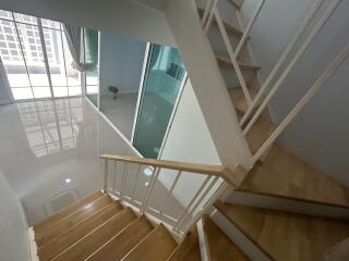 Modern staircase in a well-lit interior with reflective surfaces