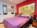 Vibrant Asian-inspired bedroom with decorative wall art and rich color palette