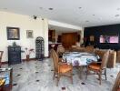 Spacious living room with marble flooring and integrated dining area