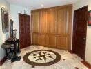 Spacious hallway with decorative marble floor and wooden cabinets