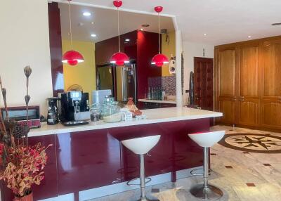 Modern kitchen with bar seating and stylish red accents