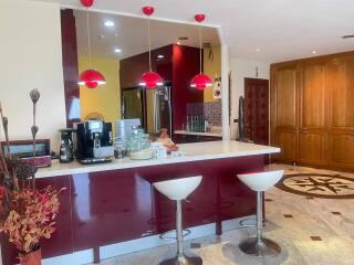 Modern kitchen with bar seating and stylish red accents