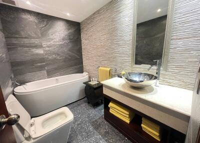 Modern bathroom with stylish fixtures and marble tiling