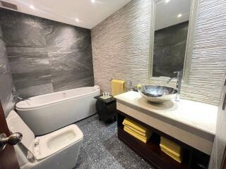 Modern bathroom with stylish fixtures and marble tiling