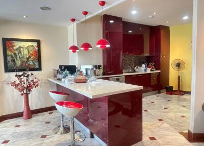 Modern kitchen with red accents and stylish bar stools