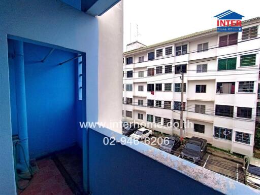 Compact balcony overlooking an apartment building