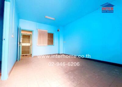 Spacious blue bedroom with large window and air conditioning unit