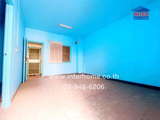 Spacious blue bedroom with large window and air conditioning unit