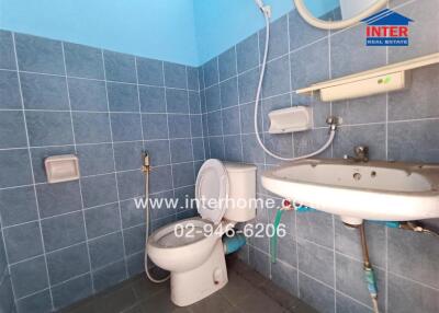 Brightly lit bathroom with blue tiles featuring modern fixtures