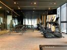 Modern gym facility with various exercise machines in a residential building