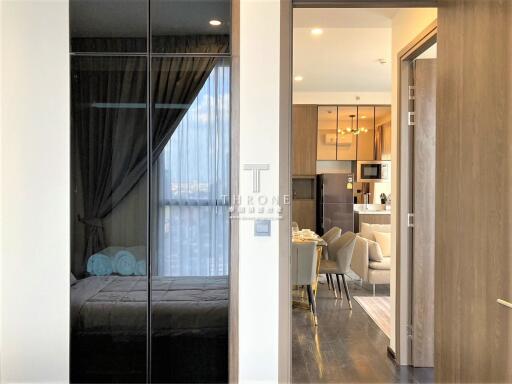 Modern apartment interior view showing bedroom and kitchen