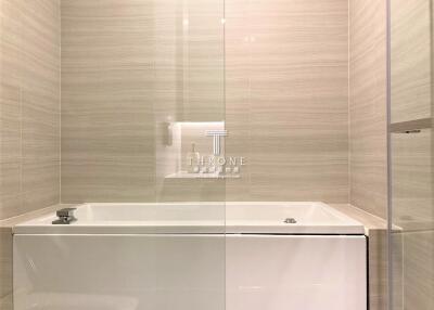 Modern bathroom with elegant bathtub and tiled walls