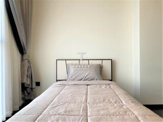 minimalist designed bedroom with neat bedding and elegant decor