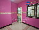 Vibrant pink bedroom with ceramic floor tiles and secure window grills