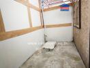 Empty storage room with wooden shelves and cement flooring