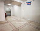 Spacious empty room with tiled flooring and white walls