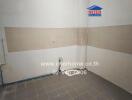 Empty kitchen space with wall tiles and plumbing fixtures