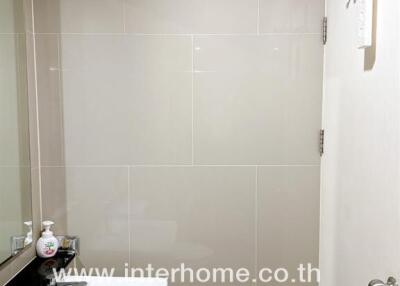 Modern bathroom with white fixtures and tiled walls