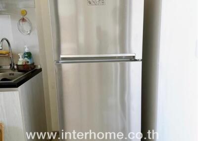 Modern kitchen with stainless steel refrigerator