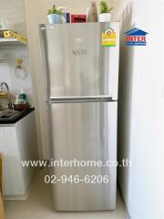 Modern kitchen with stainless steel refrigerator