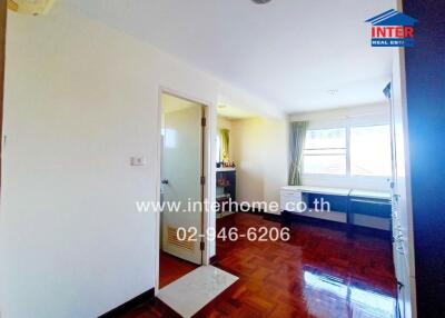 Bright and spacious bedroom with hardwood floors and ample natural light