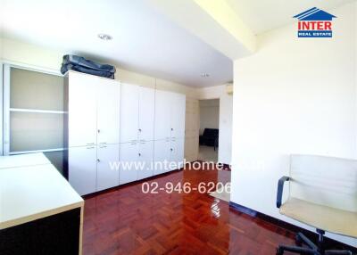 Spacious bedroom with large wardrobes and parquet flooring