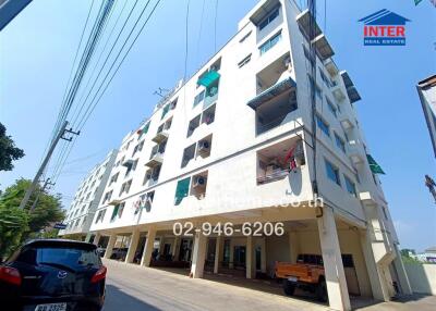 Exterior view of a modern residential building with unique window patterns