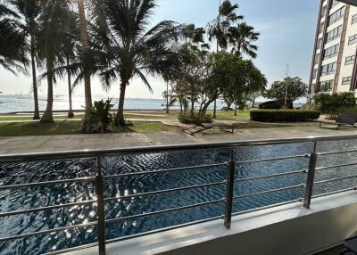 Luxury seaside apartment balcony view with pool and garden