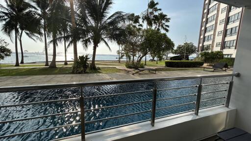 Luxury seaside apartment balcony view with pool and garden