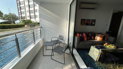Modern living room with balcony overlooking pool