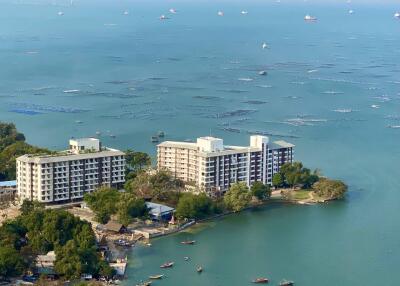 Aerial view of waterfront residential buildings with boats and sea