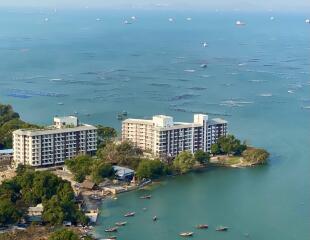 Aerial view of waterfront residential buildings with boats and sea