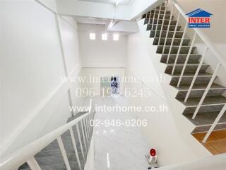 Bright and airy staircase in modern home with elegant marble flooring