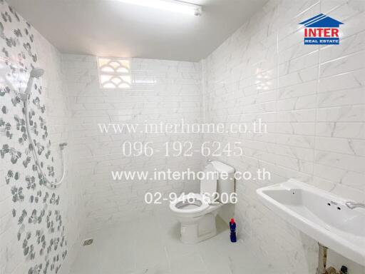 Modern tiled bathroom with toilet and sink