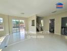 Spacious and well-lit living room with staircase and multiple entryways