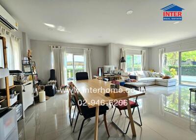 Spacious and bright living room with dining area and large windows