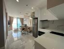 Modern apartment interior with open-plan kitchen, dining, and living area