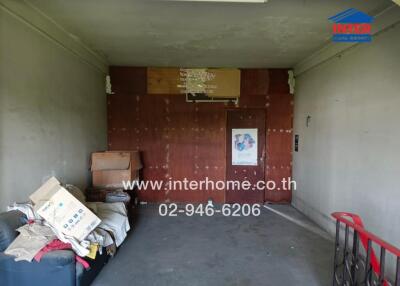 Spacious garage interior with storage capacity and cluttered with boxes